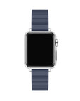 A smartwatch with a silver-toned metal case and a dark navy blue silicone strap, shown from a front-facing perspective on a solid white background.