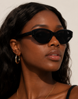 Woman wearing Josie Cateye Smart Sunglasses in black with a cateye frame