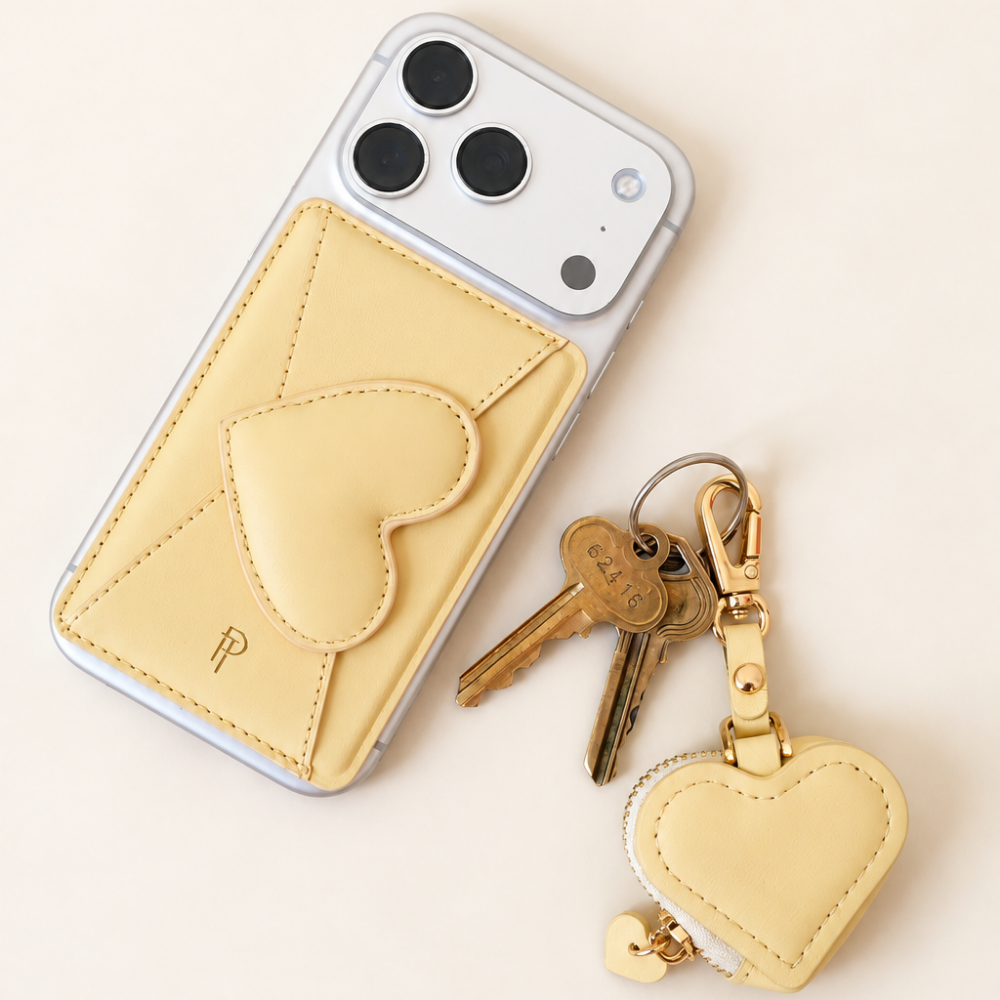 Ivory Heart Leather Magnetic Phone Wallet on white iPhone with heart keychain charm and keys