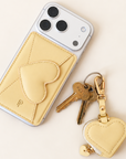 Ivory Heart Leather Magnetic Phone Wallet on white iPhone with heart keychain charm and keys