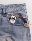 Mini digital camera in jean pocket with rainbow beaded lanyard clip